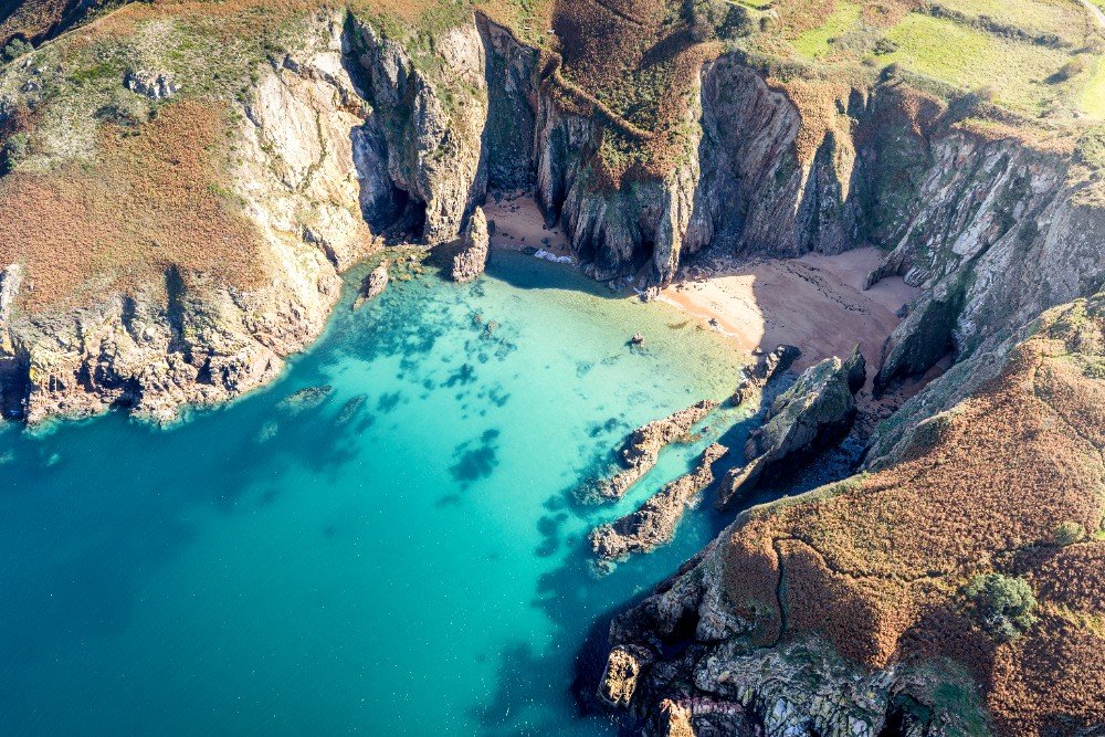 Crique aux eaux turquoise au pied des falaises de Jersey
